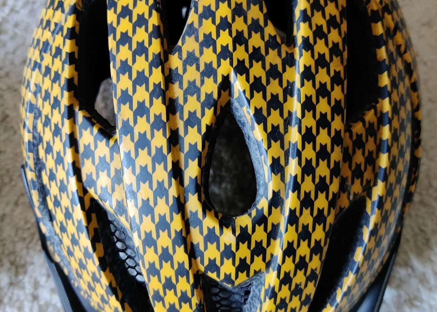 A white and yellow patterned bicycle helmet