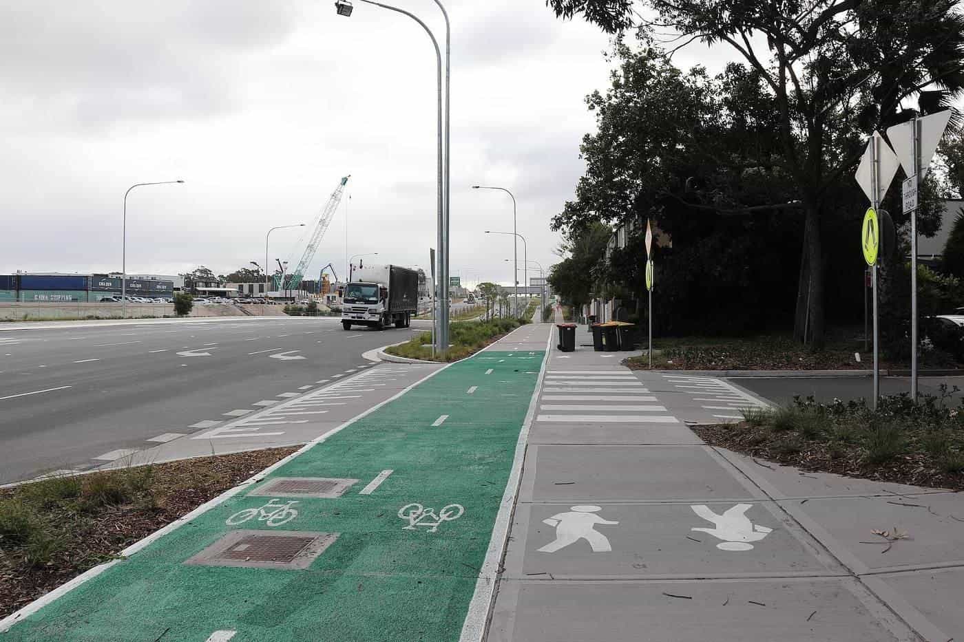 A green bicycle lane beside a shared path and a road in Sydney