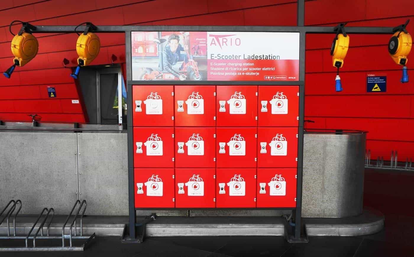 A wall of e-scooter charging lockers in a shopping centre