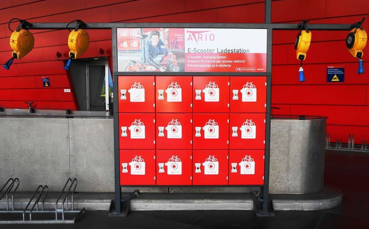 A wall of e-scooter charging lockers in a shopping centre